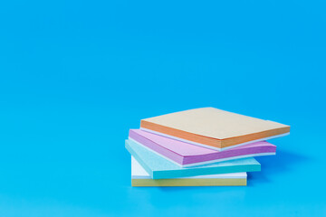 Stack of Colorful Square Notes on Blue Background