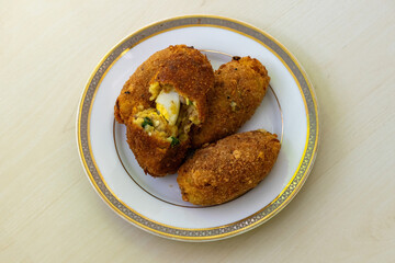Tasty homemade dim chop on a white plate against a light wooden background. This delicious and...