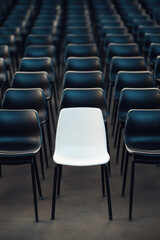 Obraz premium Single white seat amongst black seats in empty stadium