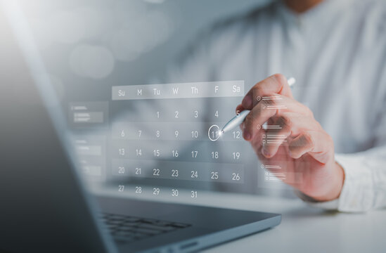 Time effective management concepts. Businessmen manage time for effectual work with calendar on virtual screen. Create an appointment, action plans, highlight reminders, and meeting agenda schedule.