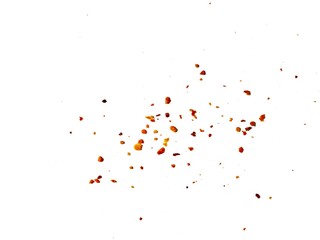 Dried red chili powder flying. Grainy scatterings of spicy burst . Splashes of red pepper powder.Overlay effect chilli or paprika spice splatters.