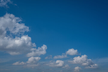 white cumulus clouds in blue sky