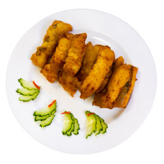 Asian restaurant serves platter of appetizers. Pieces of eel fillet, fried to crispy crust, garnished with cucumber slices. Isolated over white background