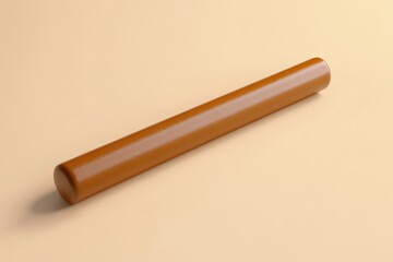 A smooth cylindrical brown object laid on a neutral background