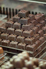 A pyramid of assorted chocolate treats fills a display case in a shop
