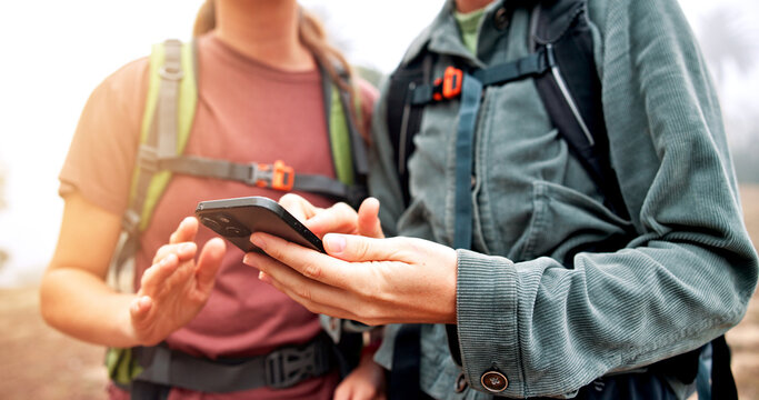 Hands, hiking and people with cellphone, direction or lost with navigation, journey or hobby. Closeup, outdoor or friends with smartphone, internet or digital app for online guide, mountain or travel