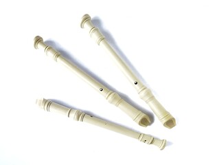 Soprano recorders. Three off-white plastic soprano recorders arranged on a white background.fipple flute. Music Instrument recorder. Block flute isolated