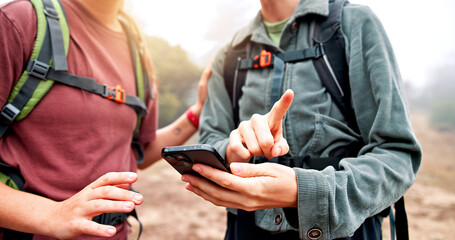 Hands, hiking and people with smartphone, direction or lost with nature, journey or hobby. Closeup,...