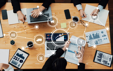 A diverse group of professionals engage in a collaborative business meeting, analyzing data with...