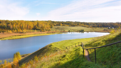 Beautiful view from the hill to Lake Gorodishchenskoye on a sunny autumn day. Fascinating Russian expanses.