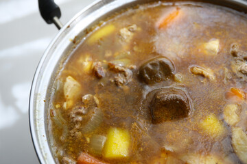preparing a Japanese style currywith fresh meat, vegetables and curry roux; home cooking