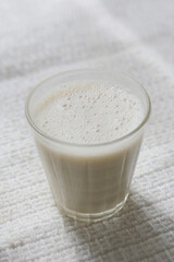 oat milk in a glass on a table