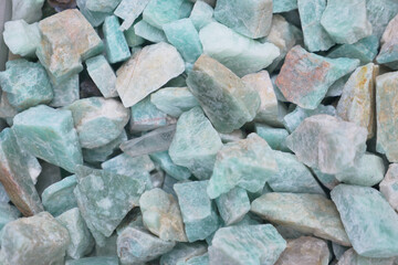 Colorful aquamarine stones scattered on surface in natural light