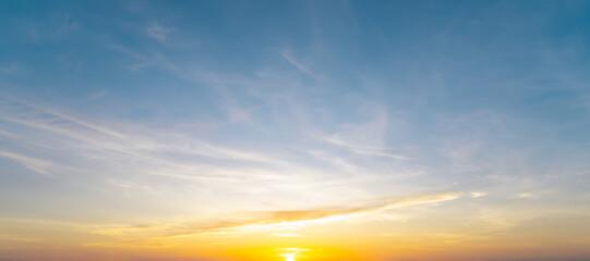 Full frame of beautiful morning or evening blue and orange sky with cloudy while sunsets or sunrises taken at the sea used as natural background texture
