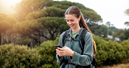 Girl, hiking and phone in woods, happy and check landmark on map, trail and notification in nature. Person, woman and smartphone on mobile app with search, direction and smile on path in Argentina