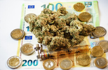 Symbol photo. cannabis blossoms and money, the big business
