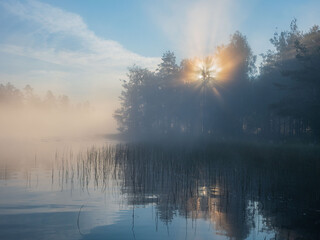 Early morning dawn on a forest lake in the Republic of Karelia in northwestern Russia. Sunrise, fog