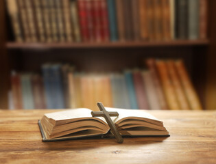 Holy Bible and Christian cross on a wooden table. Blessing and prayer