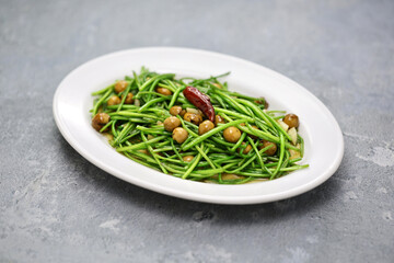 stir-fried white water snowflake stems with pickled cordia dichotoma fruits.