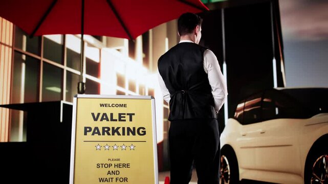 Rear View Of A Valet Standing In Front