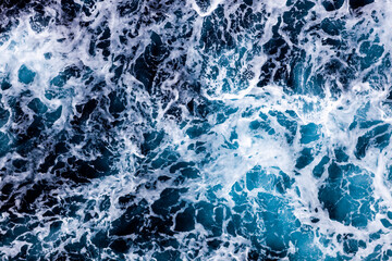 Obraz premium Sea water texture. Top view of captivating water with foam. Can be used in covers, packaging, posters, textures, banners, art and design projects. Vibrant nature background image.