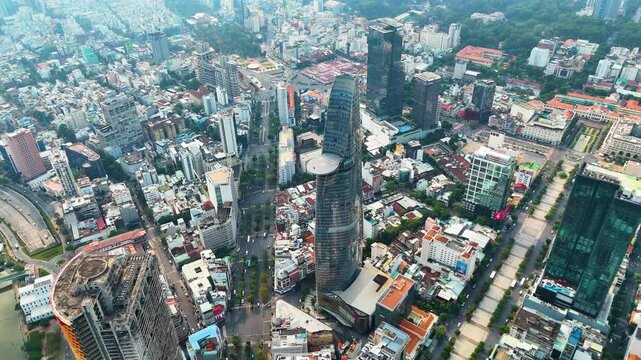 Aerial view of Ho Chi Minh City featuring the iconic Bitexco Financial Tower, showcasing modern skyscrapers, dense urban landscape, and city infrastructure in vibrant detail. Vietnam, UHD.