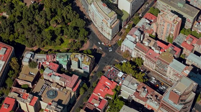 Aerial view establishing the rear entrance to Santa Lucia hill, sunny day with high traffic at a Y-shaped junction.