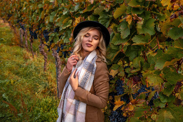 Beautiful woman enjoying nature in an autumn vineyard in Stuttgart, Germany