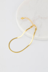 Elegant gold bracelet on marble surface for fashion and style
