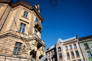 Historic architectural buildings in Lviv under a vibrant clear blue sky