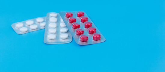 Blister Packs of Red and White Pills on Blue