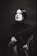 Portrait of a woman with dark hair, done in low key style.