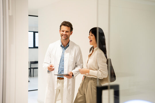 Dentist and patient having a friendly conversation in a modern office