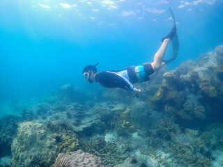 Freediver Swimming in Deep Sea DIver Eploring Sea Life.