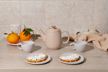 Breakfast scene featuring two plates wiCozy Breakfast Setup with Tea and Fresh Toast