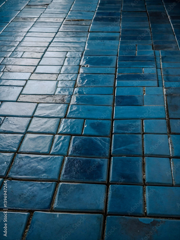 Aufkleber close-up of a floor clad in rectangular blue tiles, creating a visually appealing modern aesthetic.