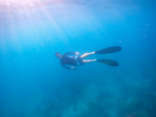 Freediver Swimming in Deep Sea DIver Eploring Sea Life.