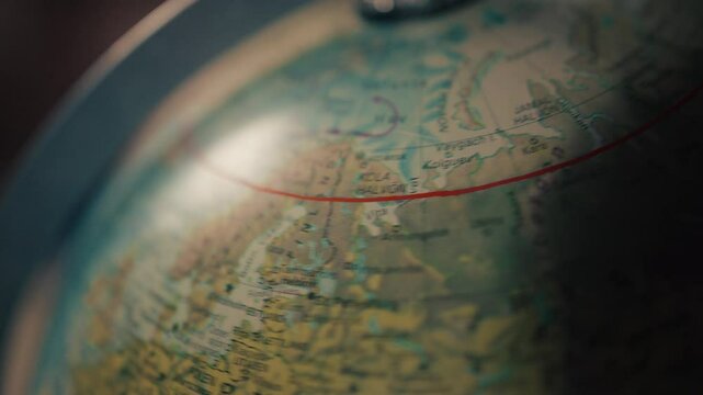 Close up of a globe map slowly rotating west and east above Northern Europe.