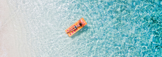 Top above high angle aerial drone view of her she fit slim sporty attractive girl floating lying on rubber mattress clean seaview water enjoy joy peaceful tranquil relax spa recreation