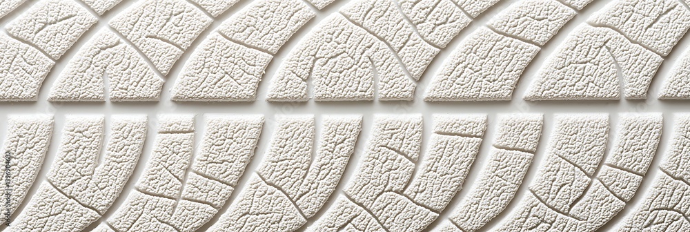 Poster a close-up view of a textured tire tread, showcasing intricate patterns designed for grip and tracti