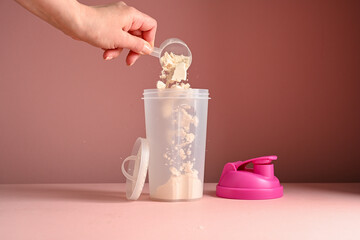 Pink, strawberry protein drink in a pink shaker, food supplement concept