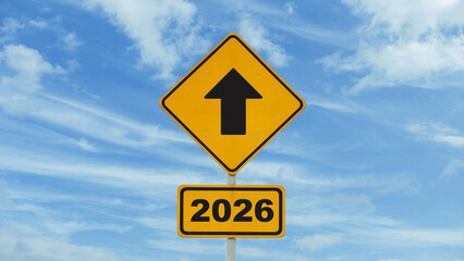 Yellow road sign arrow direction to new year 2026 on blue sky, concept. New year and new road to successful life, creative idea. Beginning 2026
