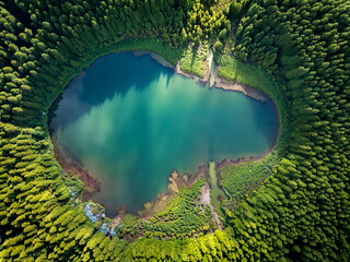 Aerial view of a turquoise lake in the middle of the forest. Typical natural scene as seen on Azores, Portugal, Europe.