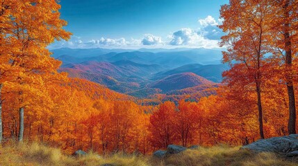Fototapeta premium Autumn's fiery trees embrace distant mountains under a bright, airy sky