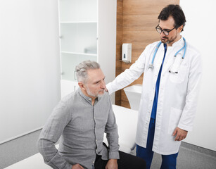 Cardiology consultation. Doctor cardiologist consulting senior male patient with heart problems...