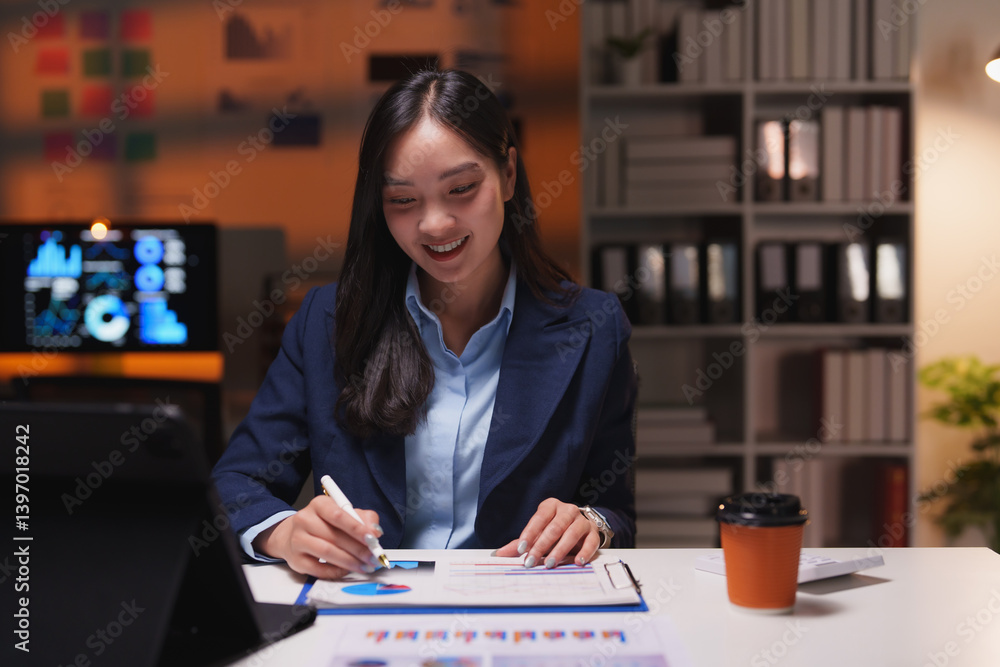 Poster young professional smiling and reviewing marketing data on documents and digital tablet, working lat