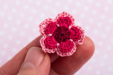 Tiny crochet flower on finger tips
