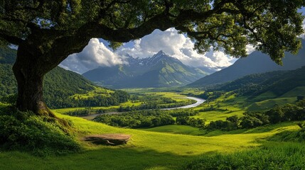 Obraz premium Picturesque valley under a large tree, mountains in the background. Lush green landscape
