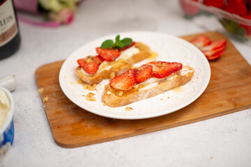 food for a romantic evening. strawberries on bruschetta and champagne