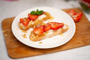 food for a romantic evening. strawberries on bruschetta and champagne